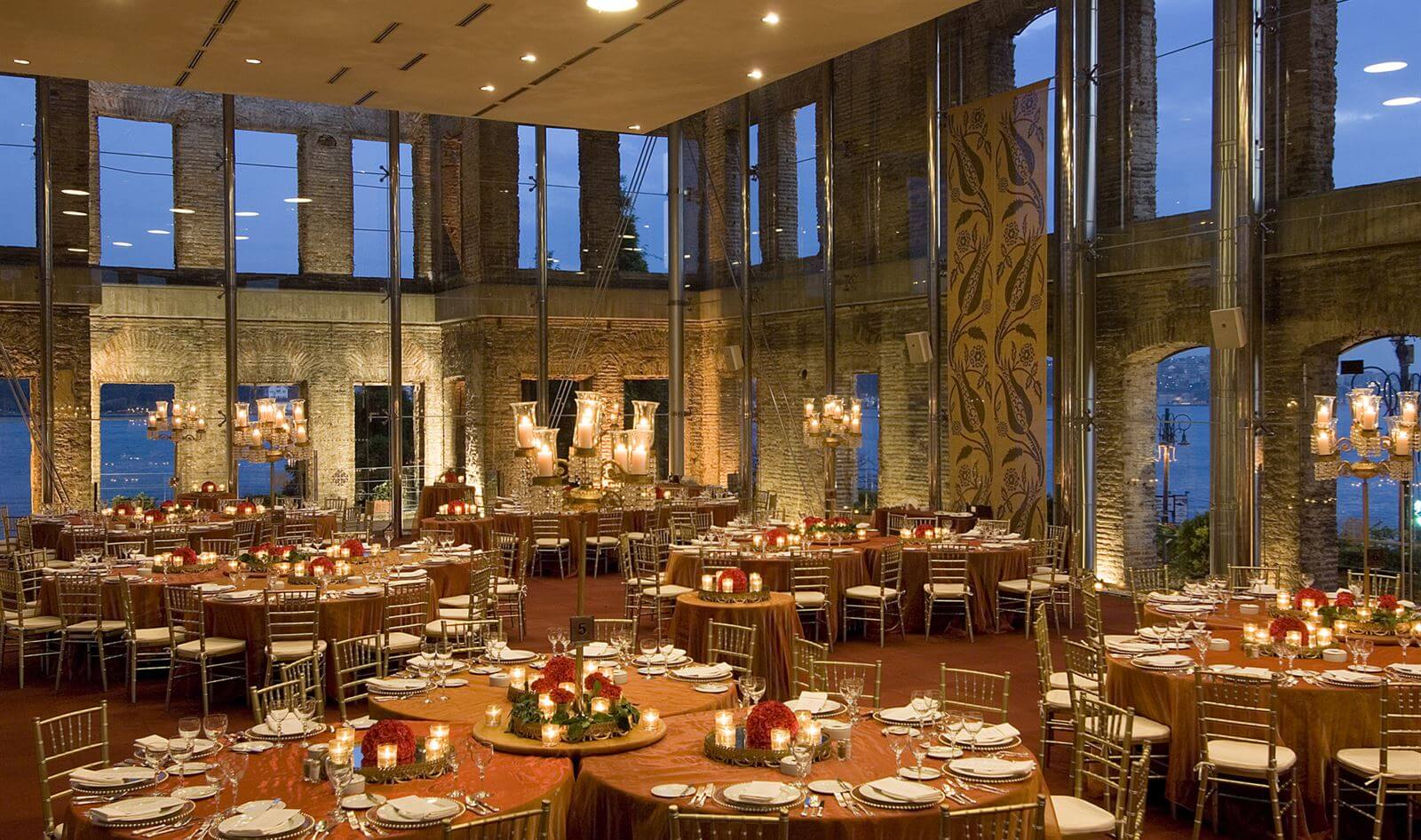Elegant event setup at Esma Sultan in Istanbul with round dining tables and evening lighting.